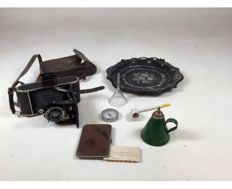 A vintage Voigtlander camera in leather case also with a card case , a vintage can, a compass and other items 