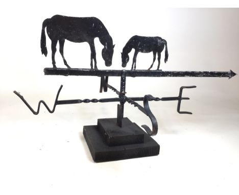 A weather vane with horse decoration on two river wooden plinth. W:78cm x D:58cm x H:44cm