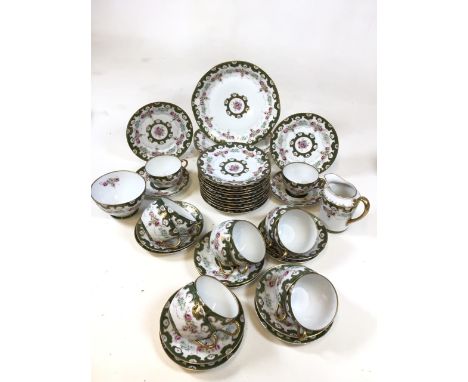 A German Beyer &amp; Bock porcelain tea set for twelve, early twentieth century. Includes cups, saucers, tea plates, jug and 