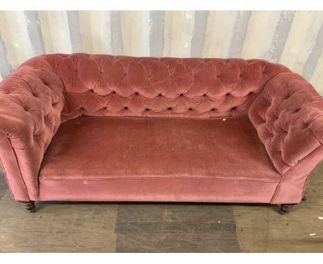 A button back upholstered chesterfield sofa. Victorian settee with drop arm. 