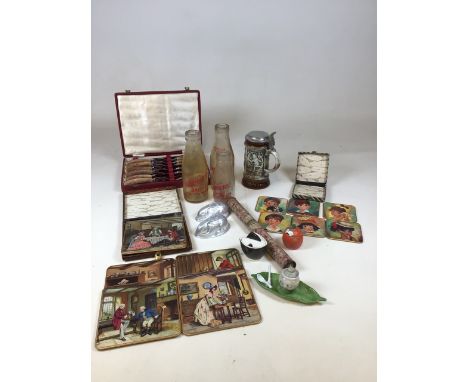 A boxed set of horn handled cutlery, vintage place and drinks mats, vintage milk bottles from Pankhurst farm dairy, Woking an