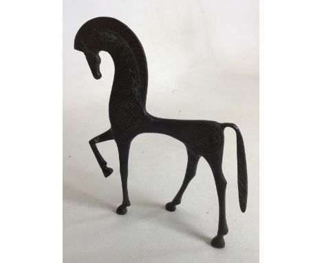 A bronze style sculpture of a horse with engraved symbols on body W:17cm x H:21cm