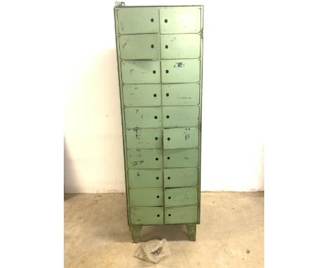 A bank of mid century metal pigeon hole lockers with original vintage green paint, with locks. Of reverse tapered form. 