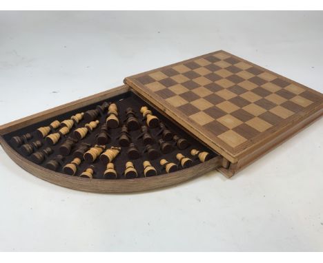A complete wooden chess set with pull out drawer with storage for pieces. 