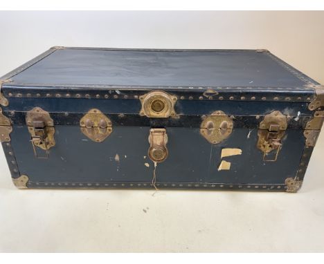 A vintage suitcase. Metal bound with a lined interior. W:52cm x D:90cm x H:35cm