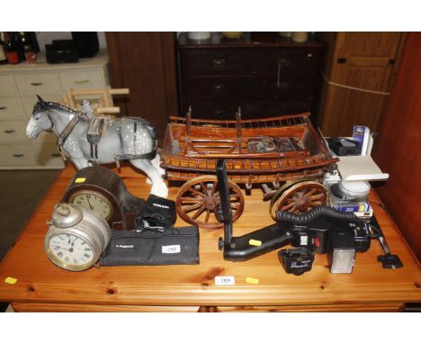 An oak cased mantle clock, a model of a horse and cart, together with various camera accessories