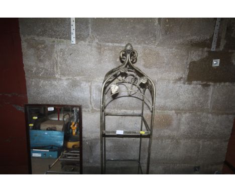 A metal and glass floral patterned four tier shelf