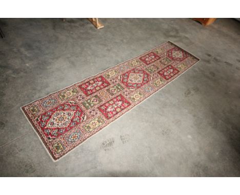 An approx. 8'10" x 2'3" patterned runner and a small floral rug