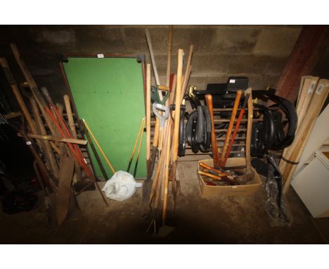 A quantity of wooden handled gardening tools to include a hoe; slasher; digging fork and spade etc.