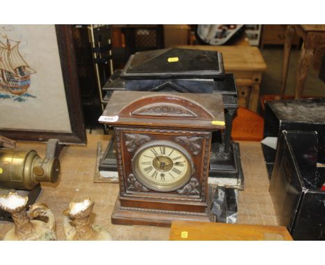 A black slate mantle clock AF and an oak cased mantle clock 