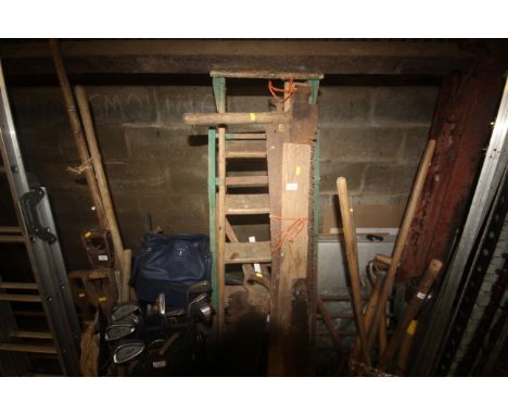 A set of wooden steps and a quantity of vintage hand saws
