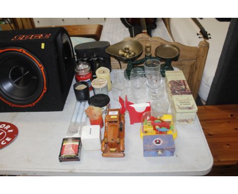 A set of scales and weights, various glassware, advertising tins, wooden model of a car etc.