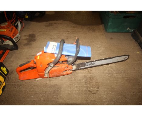 A Husqvarna 350 petrol chainsaw with instruction guide
