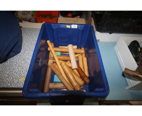 A box containing a quantity of turned wooden handles for tools etc.