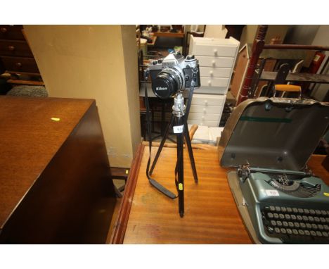 A Nikon FE camera and tripod