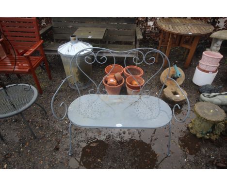 A wrought metal two seater garden bench