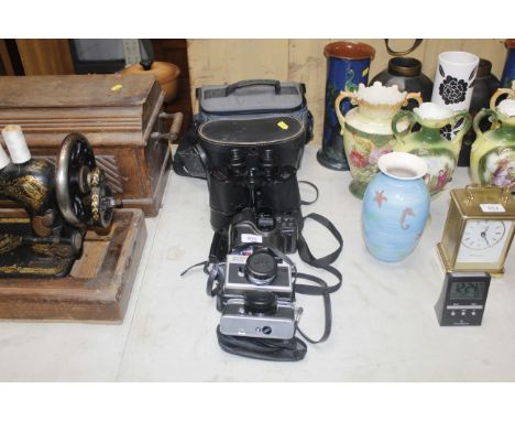 A pair of Prinz 10 x 50 binoculars, an Olympus camera, together with two others