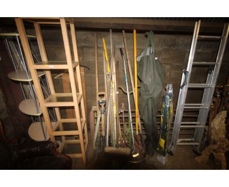 A large quantity of gardening tools to include a rake; digging spade; a broom; a Wolf Tools cultivator etc.