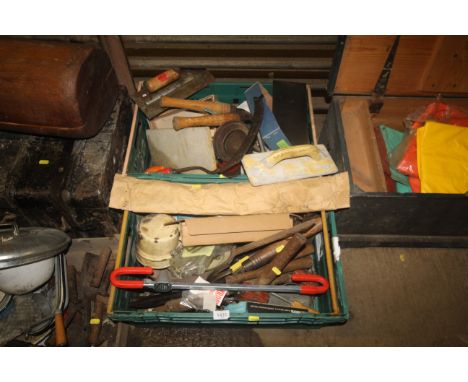 Two boxes containing various tools to include shears; a steering wheel lock; a hammer; a sickle etc.