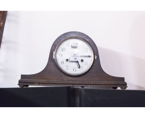 A TWENTIETH CENTURY OAK CASED NAPOLEONS HAT SHAPED MANTEL CLOCK, SILVERED DIAL AND BLACK NUMERALS 