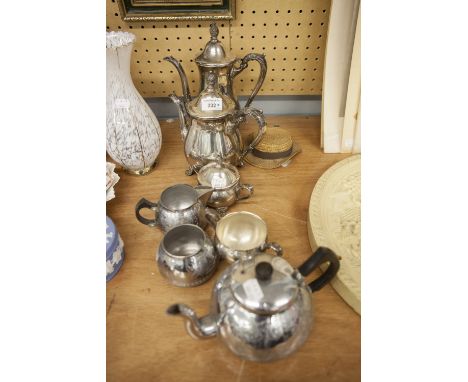 A SILVER PLATE TEA/COFFEE SERVICE OF FOUR PIECES AND ANOTHER OF THREE PIECES 