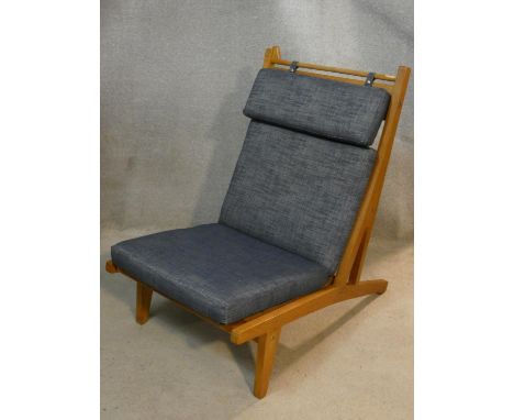 After Hans J Wegner, a mid century light oak reclining easy chair with removable cushions. H.94 