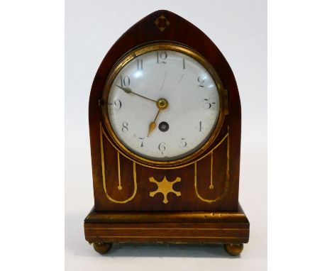 A Regency lancet bracket clock in brass inlaid mahogany case with white enamel dial and Arabic numerals resting on brass bun 