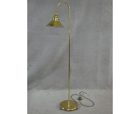 A brass floor standing adjustable lamp. H.147cm 