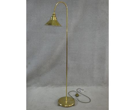 A brass floor standing adjustable lamp. H.147cm 