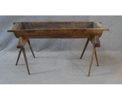 A large antique bread proving trough on a pair of tripod trestle supports. H.69 L.140 W.42cm 