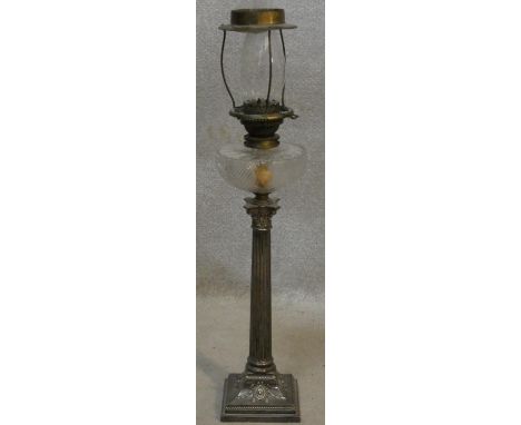 A tall late 19th century oil lamp with cut crystal reservoir standing on a silver plated Corinthian column pedestal with embo