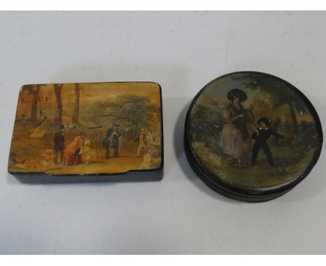 Two antique hand painted black papier-mâché snuff boxes one with a mother and a young boy and one with a family looking throu