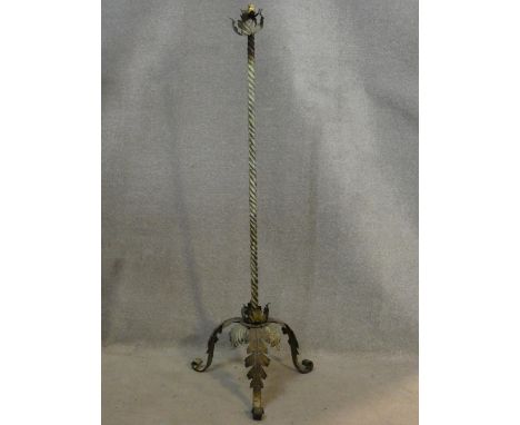 A vintage wrought iron standard lamp stand with spiral twist central column on tripod scrolling foliate base. H.147 