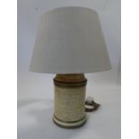 A John Lewis paper effect ceramic cylindrical table lamp with calligraphy and gilded details. Makers
