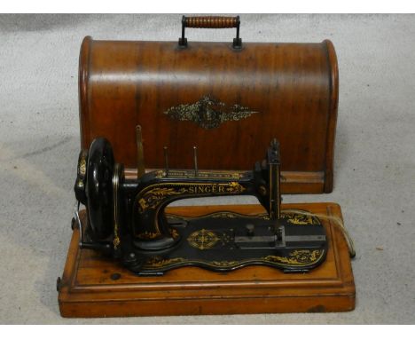 A late 19th century Singer sewing machine in fitted carrying case with original user's manual. H.32 L.45 W.24cm 