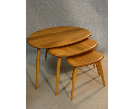 A vintage nest of three light elm and beech Ercol pebble tables. H.41 L.65 W.44cm 