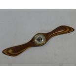 A barometer mounted on a vintage laminated propeller. L.57cm