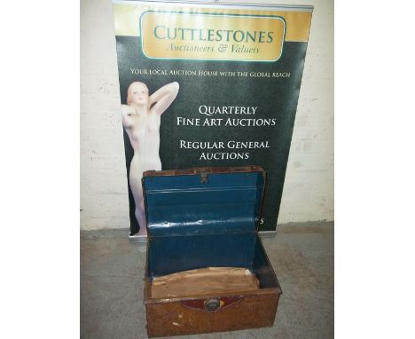 A SMALL METAL TRAVEL TRUNK