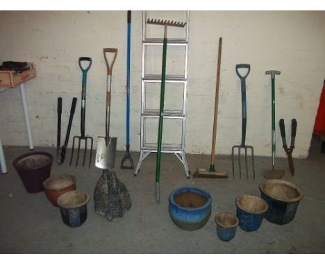 A SELECTION OF GARDEN TOOLS AND GLAZED PLANTERS WITH A CONCRETE SWAN PLANTER