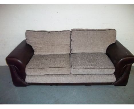 A THREE SEATER FABRIC / FAUX LEATHER SOFA