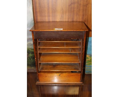 A VINTAGE WOODEN STATIONARY CABINET