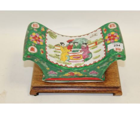 AN ORIENTAL CERAMIC PILLOW ON STAND