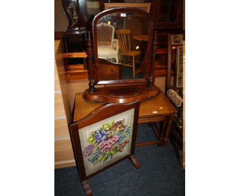 AN ANTIQUE MAHOGANY SWING MIRROR TOGETHER WITH AN OAK EMBROIDERED FIRE SCREEN (2)
