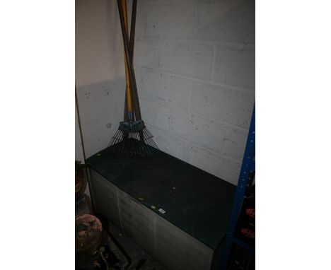 AN OUTDOOR STORAGE BOX PLUS SOME GARDENING TOOLS