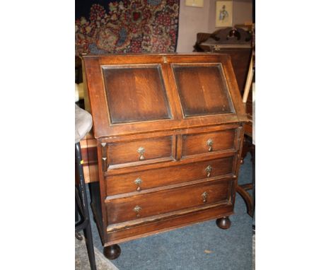 A VINTAGE OAK BUREAU WITH FOUR DRAWERS