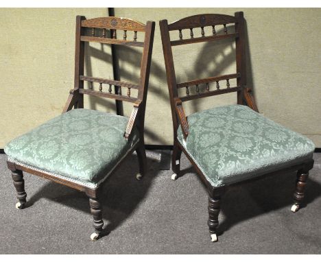A pair of mahogany nursing chairs, on original ceramic castors, 77cm high