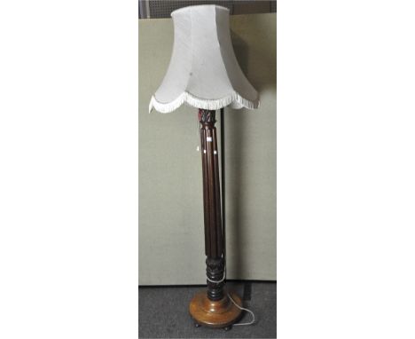 A large early 20th century standard lamp, carved column form, with shade, 141cm high