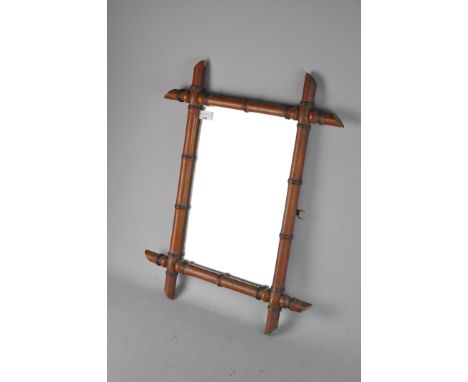 A vintage faux bamboo framed mirror, possibly French, 62cm x 50cm