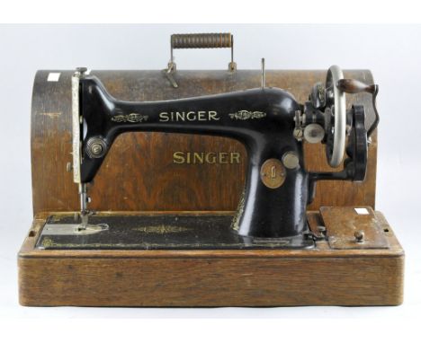 A vintage Singer sewing machine, Y5105488, in original wooden carry case