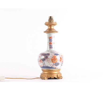 A Chinese Imari bottle vase, Qing, 18th century. Decorated with peony and trellis and with ormolu mounts. Now fitted as a tab